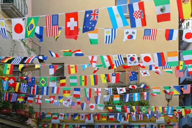 Lines with a large number of small country flags. Photo.
