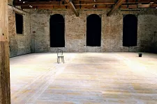 Empty room, only a chair in the middle can be seen. 