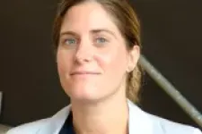 Lhinn Holmbergh wears a dark blue blouse and white jacket